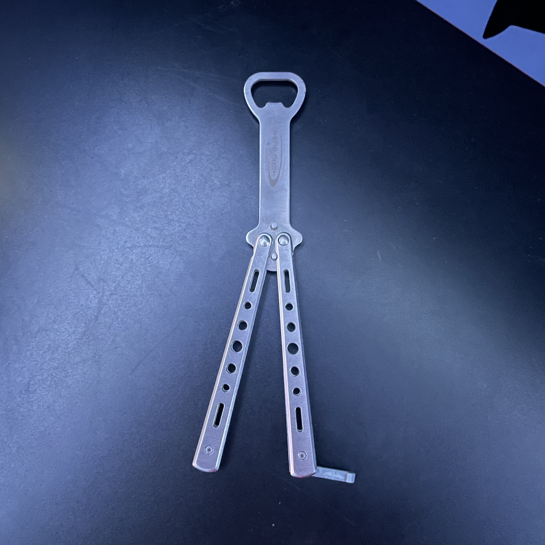 This is a bottle opener that functions like a butterfly knife and the sound of it being flipped around